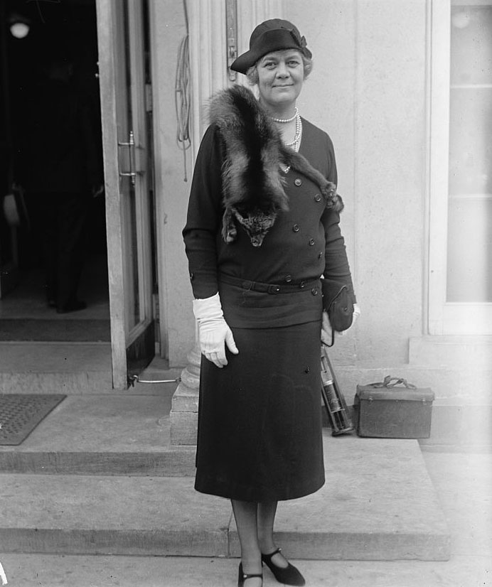 Portrait of Representative Ruth Sears Baker Pratt in a dark suit with a hat, pearls, and a fox stole